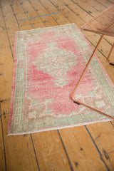 Time-softened texture of distressed Oushak rug runner, showing worn pile and secured edge.