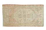Distressed vintage Oushak runner, faded central floral medallion with muted seafoam green, blush, charcoal.