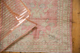 Distressed Oushak rug texture shows mostly even wear, faint foundation, pink, pale green.
