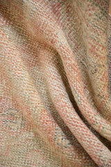 Distressed Oushak rug's mottled hand-knotted pile in pink, seafoam green, and ivory.