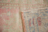 Distressed vintage Oushak runner texture with blush, seafoam colors and intact selvage.