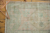 Distressed vintage Oushak rug pile texture, faint foundation, dusty rose, seafoam green.