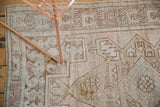 Distressed vintage Oushak rug with faded rose, sand, coffee geometric motifs.