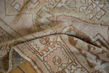 The subtle textural pattern and softened pile of the distressed Oushak rug in dusty rose and sand.
