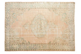 Vintage distressed Oushak carpet, pale dusty rose field, seafoam green medallion, and worn texture.