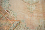 Distressed vintage Oushak texture with mostly even wear, pale rose and seafoam green motifs.