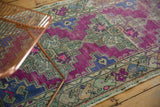 Vibrant purple violet field with distressed texture and stepped geometric motifs on Oushak runner.