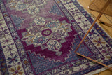Vibrant violet purple abrashes and stepped geometric motifs on a vintage Oushak runner.