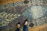 Textured distressed Oushak rug, faded lavender, mint, and pale blue patterns.