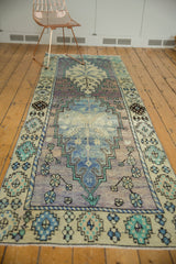 Distressed vintage Oushak runner featuring soft lavender, faded royal blue, and mint green.