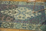 Vintage distressed Oushak rug pile detail, featuring lavender, ivory, and mint geometric patterns.