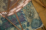 Distressed vintage Oushak runner corner reveals worn pile, secured edge, lavender, mint, blue.