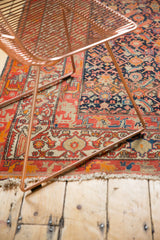 Antique Malayer rug with intricate Herati motif, tomato red geometric border, and tattered fringe.