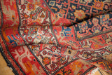 Antique Malayer rug detail showing worn red, navy, sand borders and geometric Herati motif.