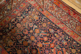 Antique Malayer rug's intricate navy Herati field and geometric Samovar border in red, sand.