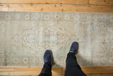 Faded ivory, beige Turkish Sparta runner with distressed texture and scalloped medallion.