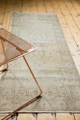 Detail of the distressed vintage Sparta rug's time-softened ivory and beige patterns.