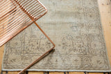 Distressed Sparta runner border detail, showing time-softened ivory and beige tones.
