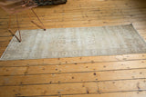 Distressed corner of the vintage Sparta runner, with faded border pattern and time-softened tones.