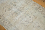 Vintage Turkish Sparta rug showing distressed low pile with faded ivory and beige pattern details.
