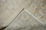Folded vintage Sparta runner, showing distressed ivory pile, fringe, and hand-knotted back.