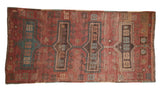 Vintage Fragment Kazak runner rug with elongated medallions in cochineal red and sky blue.