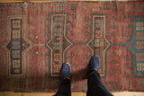 Vintage Kazak runner section with rectangular medallions, oversized hook motifs, and short, bristly pile.