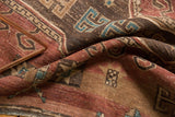 Vintage Kazak rug's bristly pile, worn to foundation, with cochineal red and powder blue motifs.
