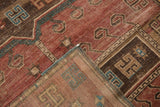 Detail of folded Caucasian Kazak runner corner revealing short pile and polychromatic selvage.