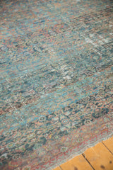 Antique Mahal carpet's intricate Herati pattern, worn pile, with foundation showing, in sapphire and wine tones.