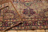Antique Kerman rug detail, displaying cochineal red, navy, and ivory traditional curvilinear patterns.