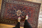 Detailed corner of a traditional Bibikabad rug, highlighting madder red, ivory, and navy borders.