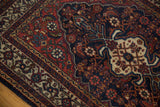 Vintage Bibikabad rug corner with madder red Herati motifs and ivory crab medallion design.