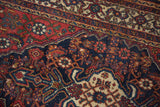 Close-up of vintage Bibikabad rug showing intricate Herati and crab motifs in madder root red and navy.