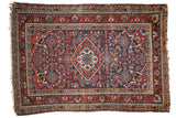 Vintage Persian Dargezine rug, madder red and navy blue diamond medallion, Herati pattern.