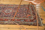 Vintage Dargezine rug showing rich red Herati field, deep blue borders, and visible frayed fringe.