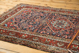 Rich madder red and navy blue Herati motif field on a traditional Persian Dargezine rug.
