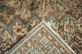 Distressed vintage Heriz rug pile, revealing woven foundation and polychromatic side cord selvage.