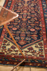 Ivory meandering vine border and navy Herati motif on a vintage Dargezine rug.