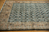Distressed green palmette field and geometric terracotta vine border on vintage Oushak rug.