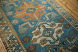 Distressed Oushak rug with Akstafa animal motif, sky blue and pale tangerine orange.