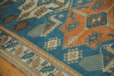 Textured distressed pile with sky blue and tangerine latched diamond patterns.