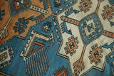 Distressed Oushak rug with Akstafa finned tail feather motif in sky blue, tangerine.
