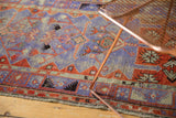 Distressed Oushak rug border, intricate geometric patterns, pale purple, red, visible wear.