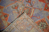 Distressed Oushak runner corner: geometric purple, red pile with wear, and woven reverse.