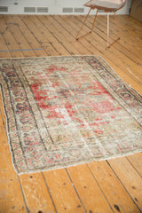 Vintage Distressed Oushak rug corner with time-softened cherry red, beige, and scrolling Rococo border.