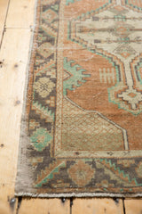 Distressed Oushak runner pile with mostly even wear and faint foundation showing, in apricot and mint geometric.