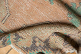 Textured pile of distressed Oushak runner with dusty apricot, mint green hues and worn finish.