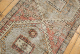 Distressed Oushak pile with even wear to knot heads, showing blush and charcoal tones.