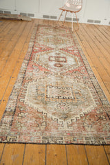 Secured end of distressed vintage Oushak rug, showcasing worn knot heads and soft blush tones.